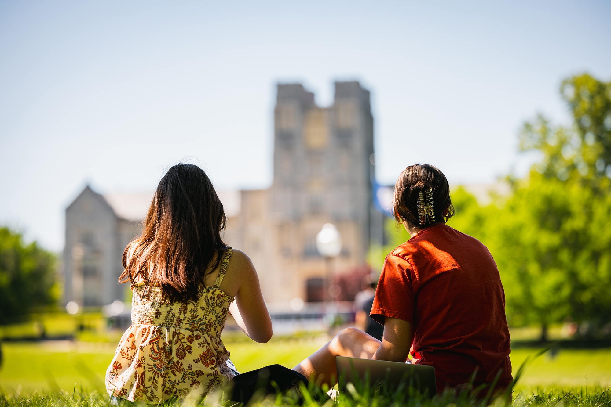 Students gazing at Burruss Hall on an sunny day